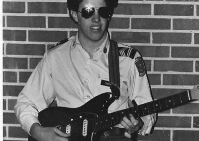 Attorney Tim Theisen playing guitar as a young man